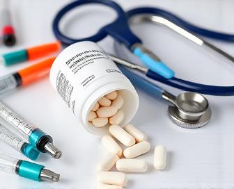 Prednisone medication bottle with a doctor in the background